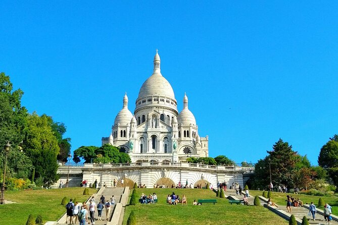 Montmartre Hill French Gourmet Food and Wine Tasting Walking Tour - Starting beneath the Moulin Rouge